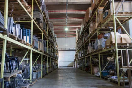 spacious warehouse filled with industrial metal shelving units giving idea about How to Start a Self Storage Business