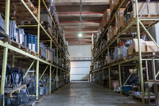 spacious warehouse filled with industrial metal shelving units giving idea about How to Start a Self Storage Business